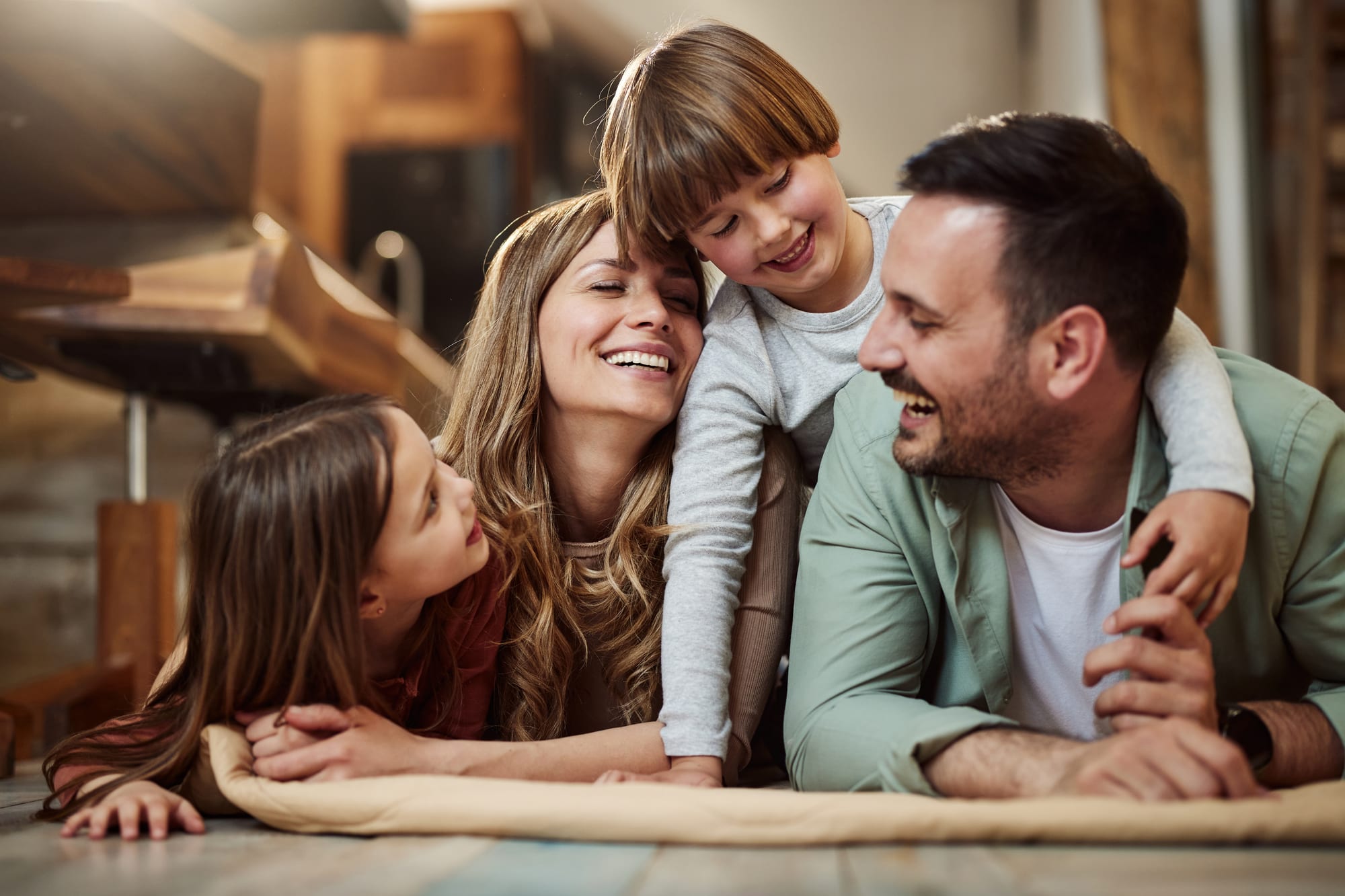 A family laughing together at home — a plan that coordinates every piece of your life