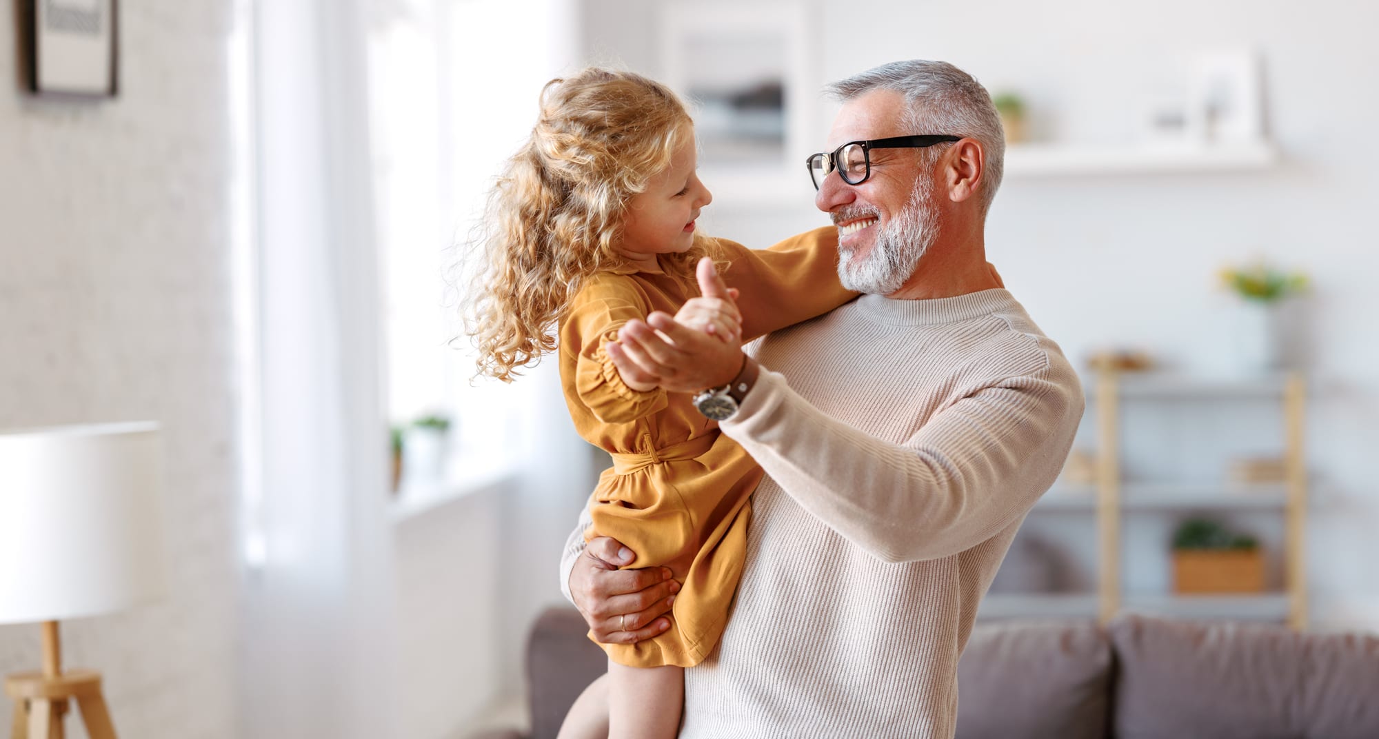Grandfather dancing with his granddaughter — the legacy an estate plan protects