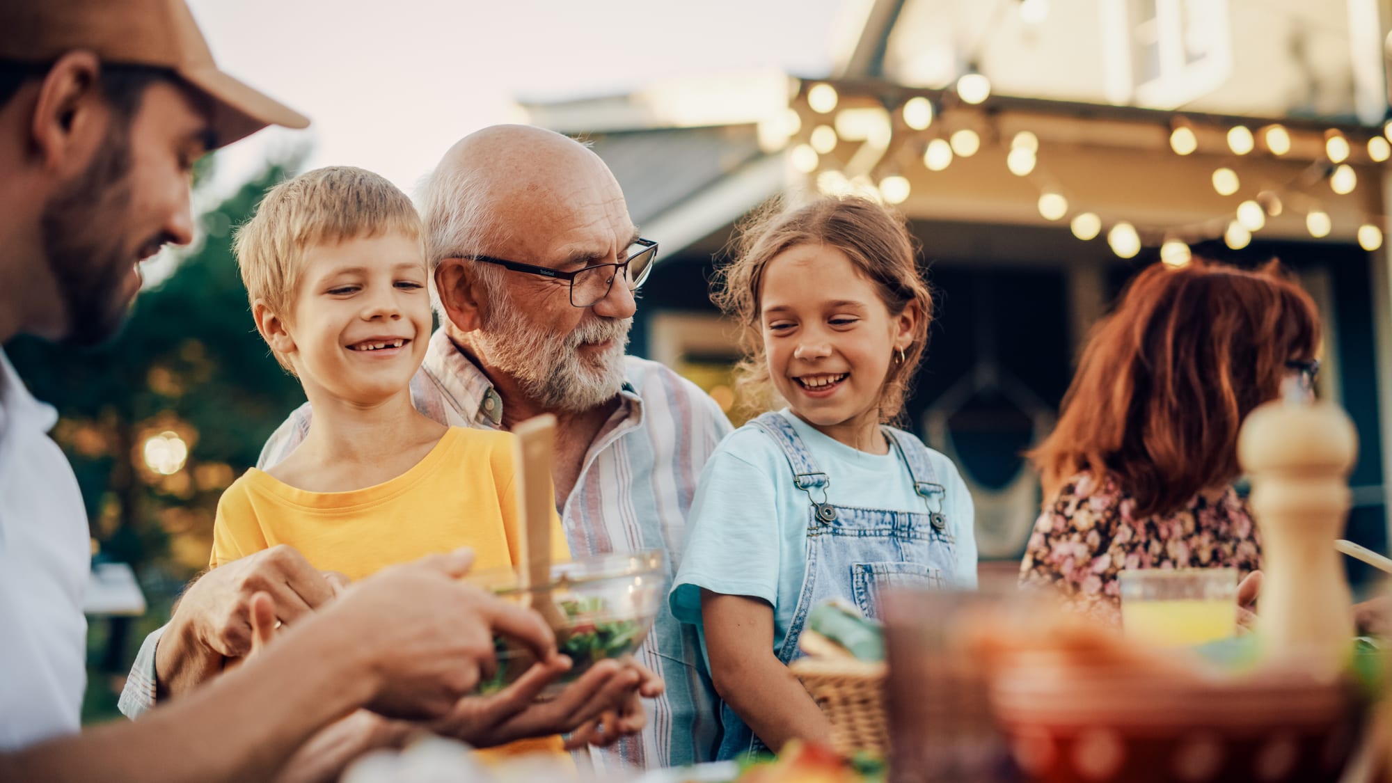 Grandfather and grandchildren at dinner — planning across generations